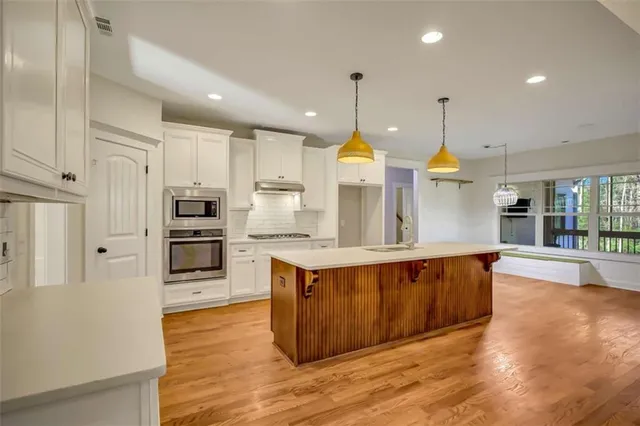 an empty room with windows and closet
