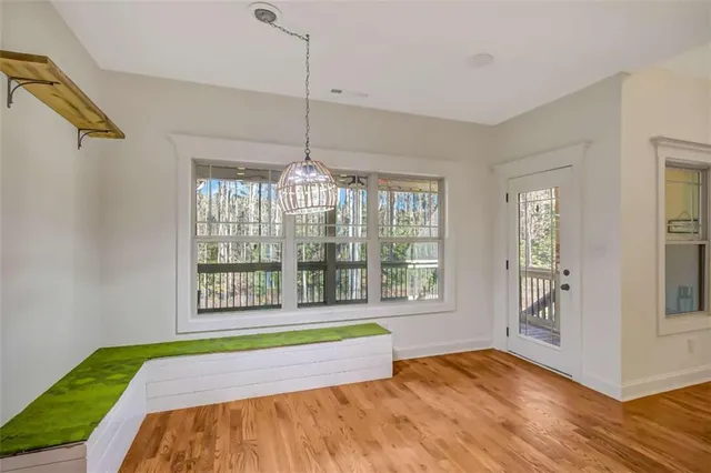 a view of a livingroom with a ceiling fan and wooden floor