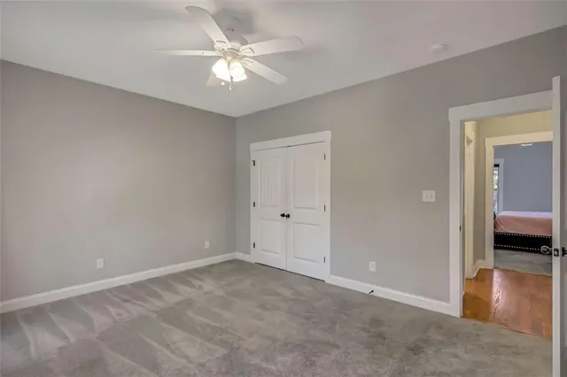a bathroom with a granite countertop sink toilet tub and shower