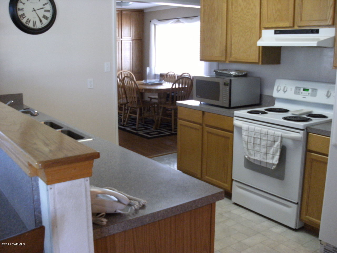1628 Saul Road Sunnyside, WA 98944 - Photo 2 of 10 a kitchen with a stove and a refrigerator