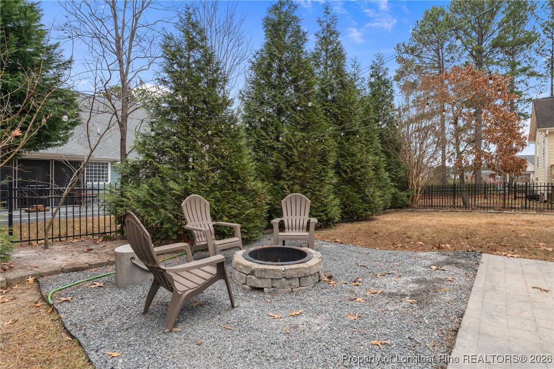 16 Cottswold Lane Spring Lake, NC 28390 - Photo 35 of 49 a backyard of a house with table and chairs