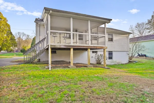a view of a house with a yard and sitting area