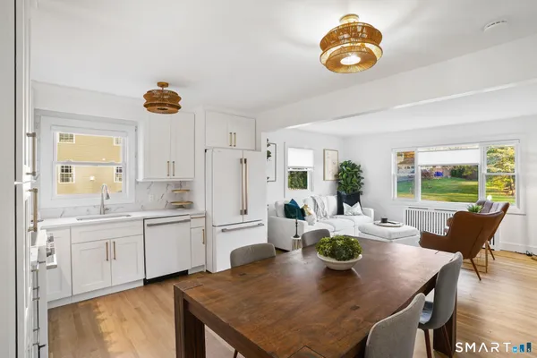 a front view of a house with a garden and plants