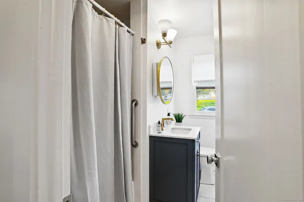 a bed sitting in a bedroom next to a window