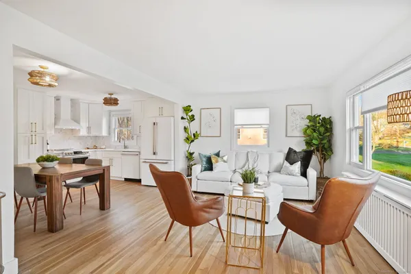 a kitchen with stainless steel appliances white cabinets and wooden floor