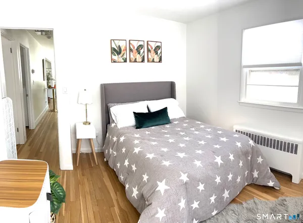 a white toilet sitting next to a bathroom sink and a mirror