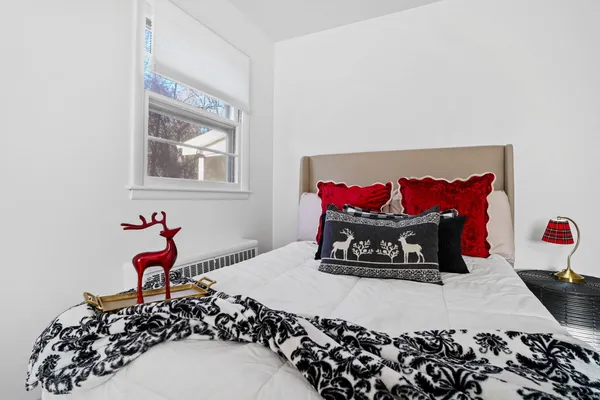 a bedroom with a large bed and a potted plant
