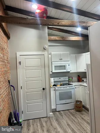 a kitchen with a refrigerator and a stove