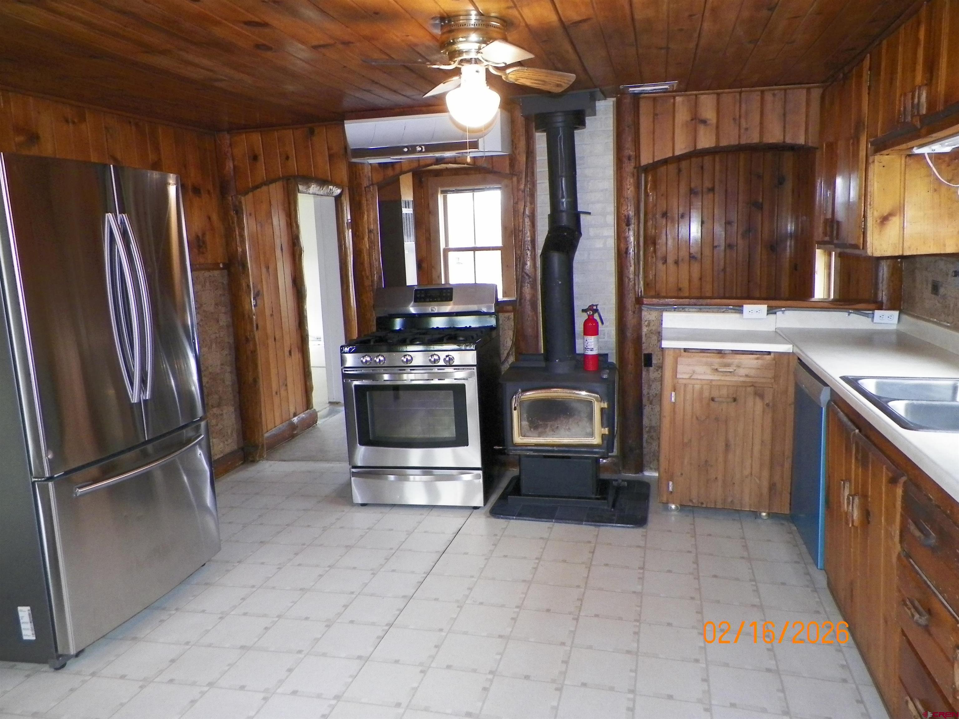 20856 2300th Road Cedaredge, CO 81413 - Photo 18 of 45 a kitchen with granite countertop a refrigerator and a stove top oven