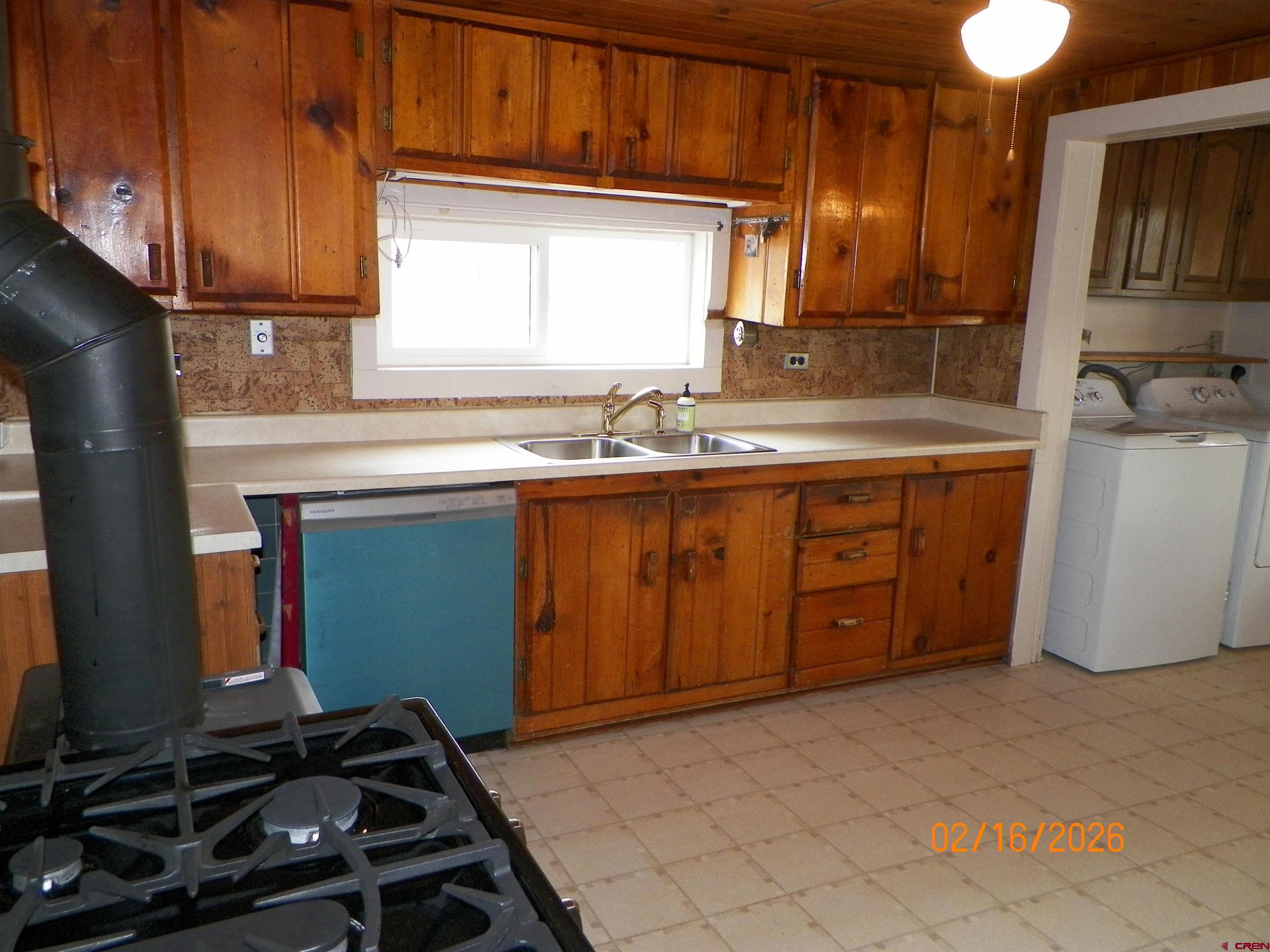 20856 2300th Road Cedaredge, CO 81413 - Photo 19 of 45 a kitchen with a sink stove and cabinets