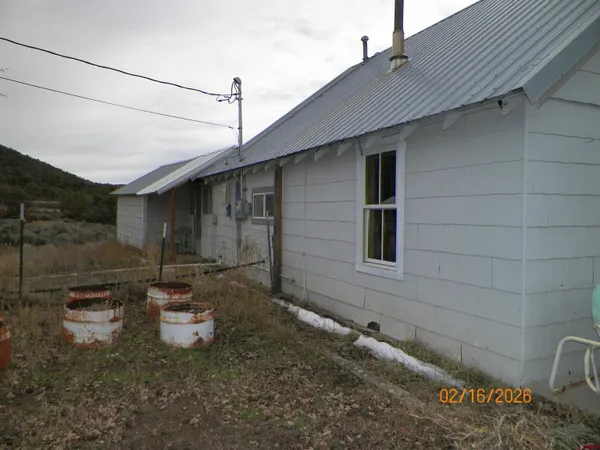 a view of a backyard with barn in the background