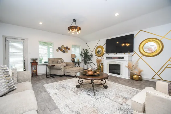 a living room with furniture a rug and a fireplace