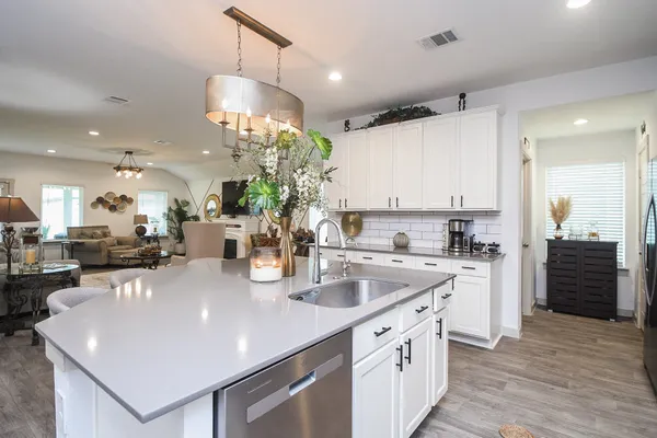 a kitchen with stainless steel appliances granite countertop a sink a stove and a refrigerator