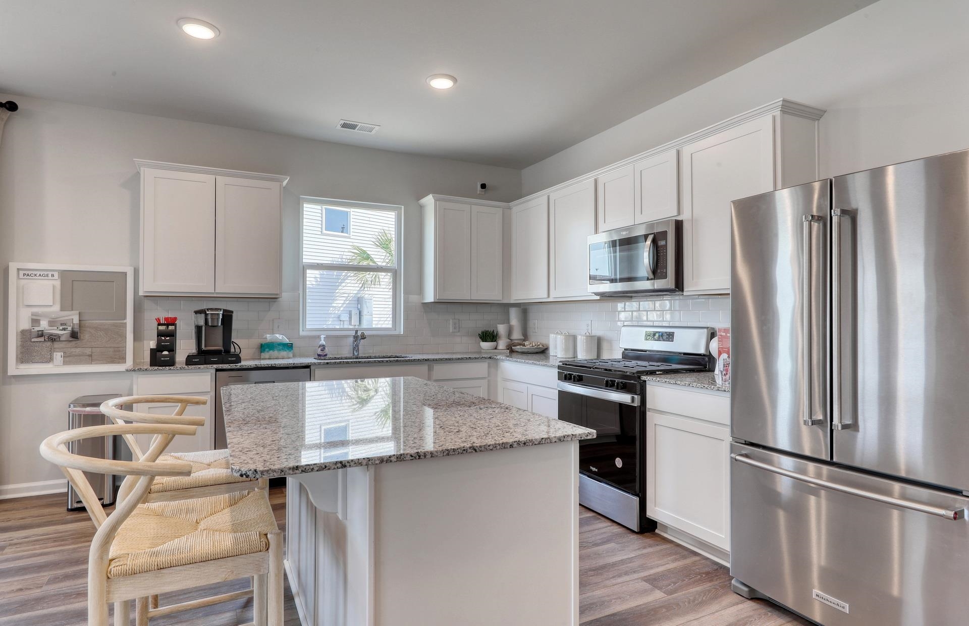 799 Laconic Drive Myrtle Beach, SC 29588 - Photo 9 of 21 Kitchen with appliances with stainless steel finishes, white cabinetry, tasteful backsplash, and recessed lighting