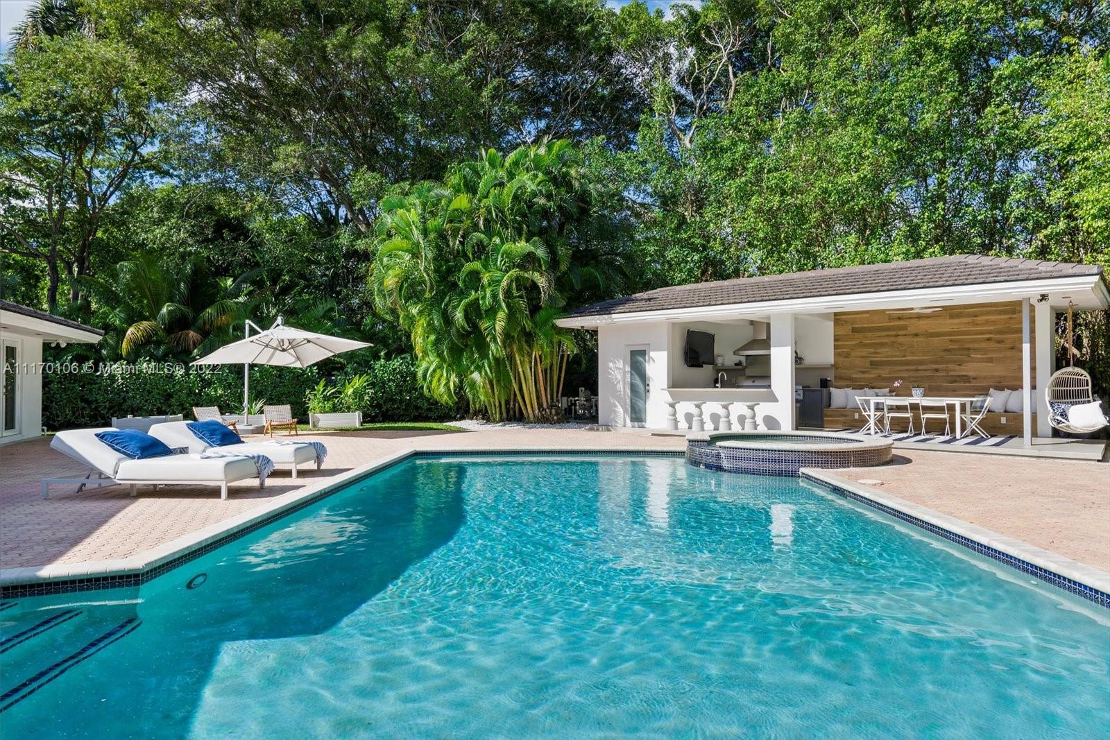 a view of a house with swimming pool and sitting area