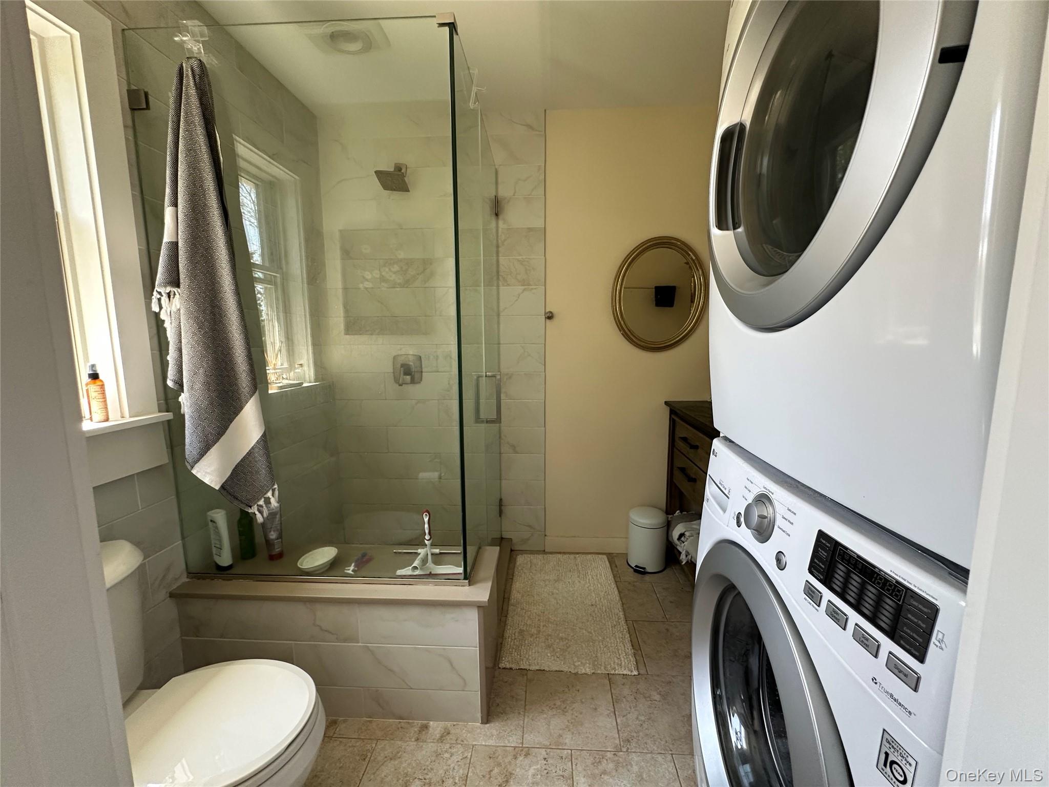 1854 North Bayview Road Southold, NY 11971 - Photo 19 of 20 Bathroom with stacked washer / drying machine and a stall shower