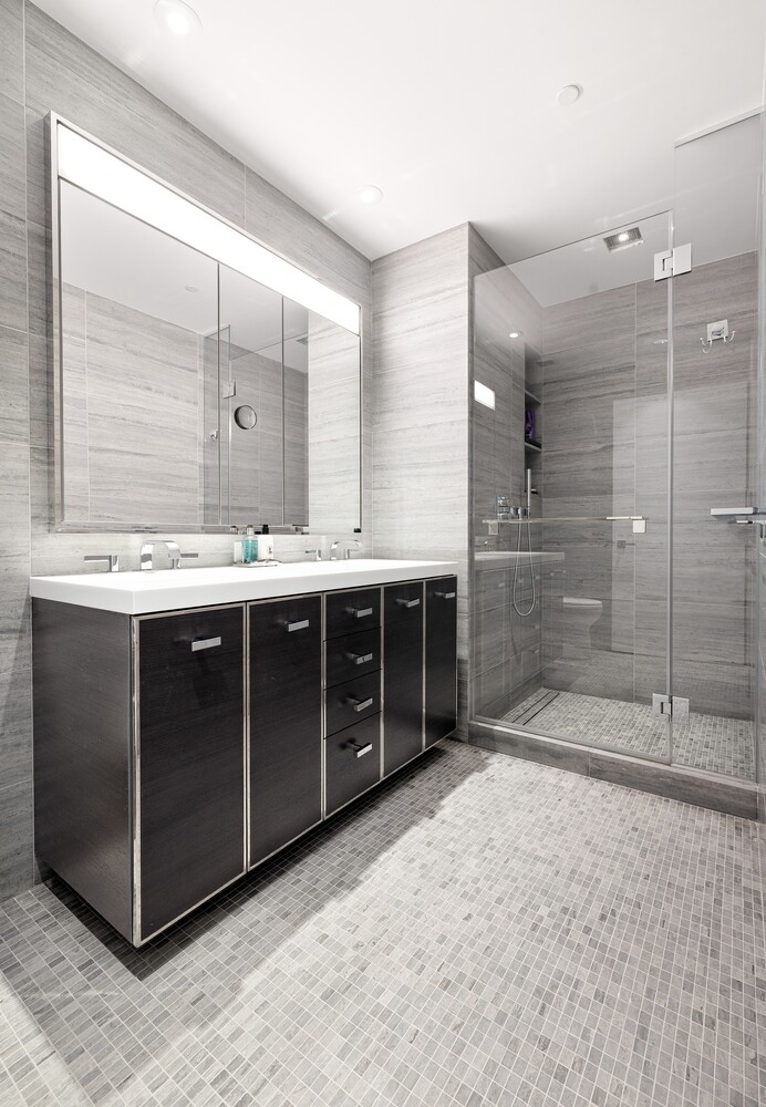 252 South Street, Unit 36C Manhattan, NY 10002 - Photo 10 of 32 a spacious bathroom with a granite countertop sink mirror and shower