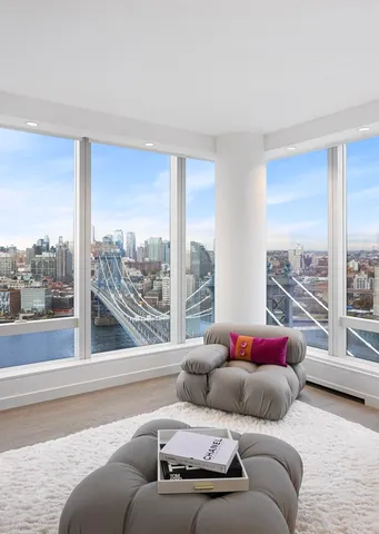 a living room with couch and a floor to ceiling window