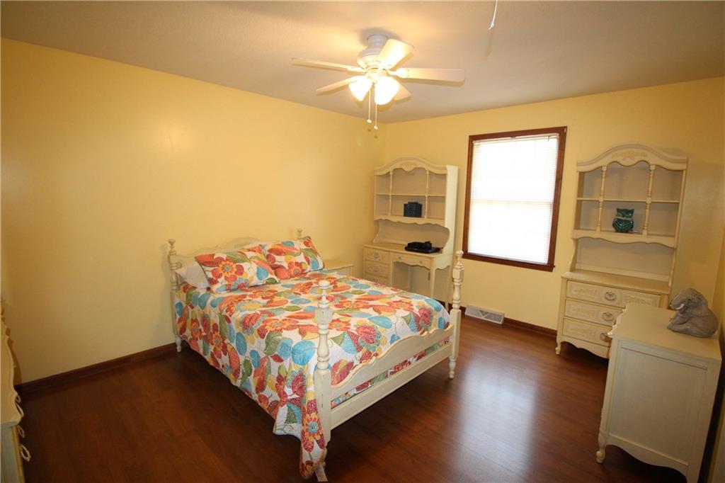 306 Sygan Road McDonald, PA 15057 - Photo 12 of 24 Second bedroom with ceiling fan and laminate flooring.