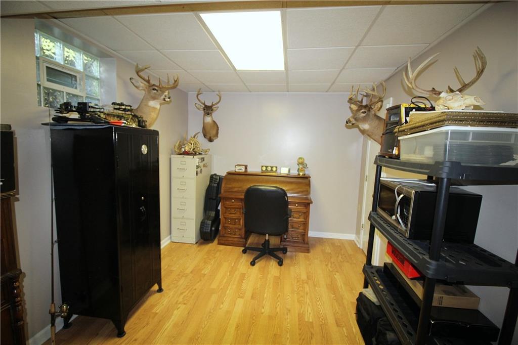 306 Sygan Road McDonald, PA 15057 - Photo 17 of 24 Den or 4th bedroom on lower level has laminate flooring and a closet.