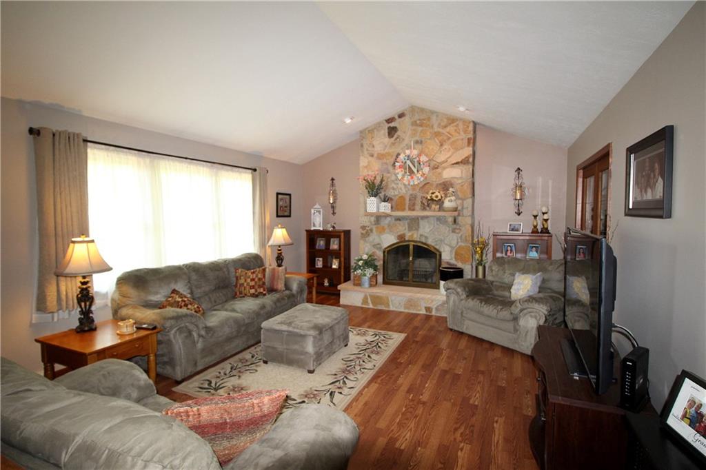 306 Sygan Road McDonald, PA 15057 - Photo 3 of 24 Huge living room with vaulted ceiling, laminate flooring and an impressive stone fireplace.