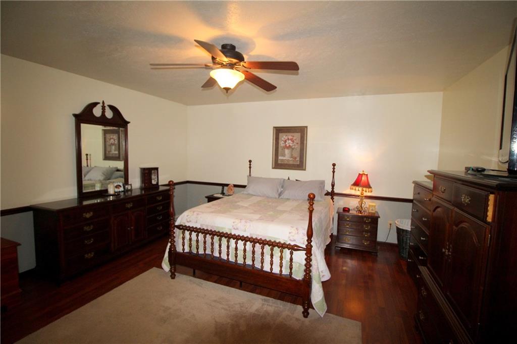 306 Sygan Road McDonald, PA 15057 - Photo 9 of 24 Master bedroom with ceiling fan and laminate flooring.