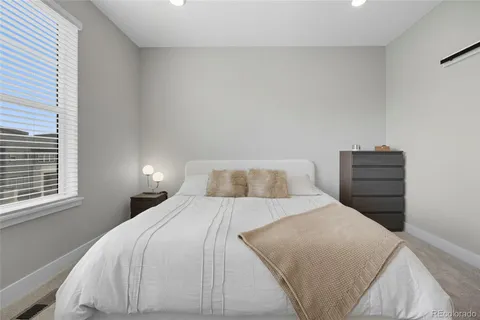 a bedroom with a bed and dresser