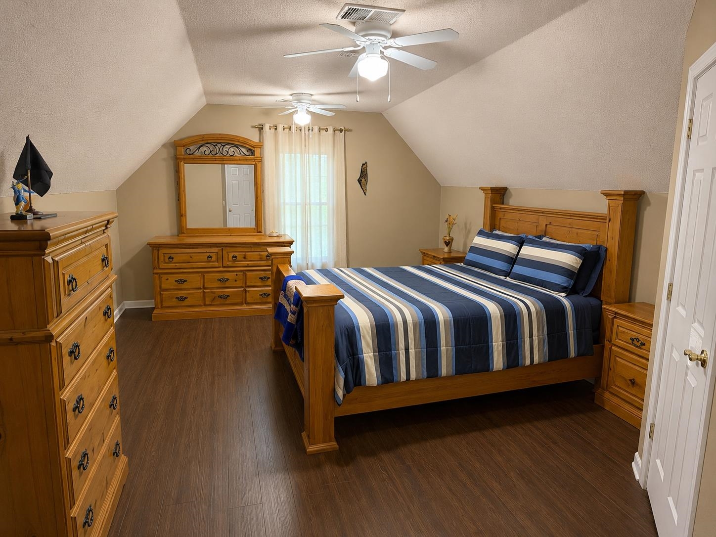 326 South Sanga Road Cordova, TN 38018 - Photo 26 of 32 Spacious room featuring wood-finish flooring, an angled ceiling, and two ceiling fans with integrated lighting