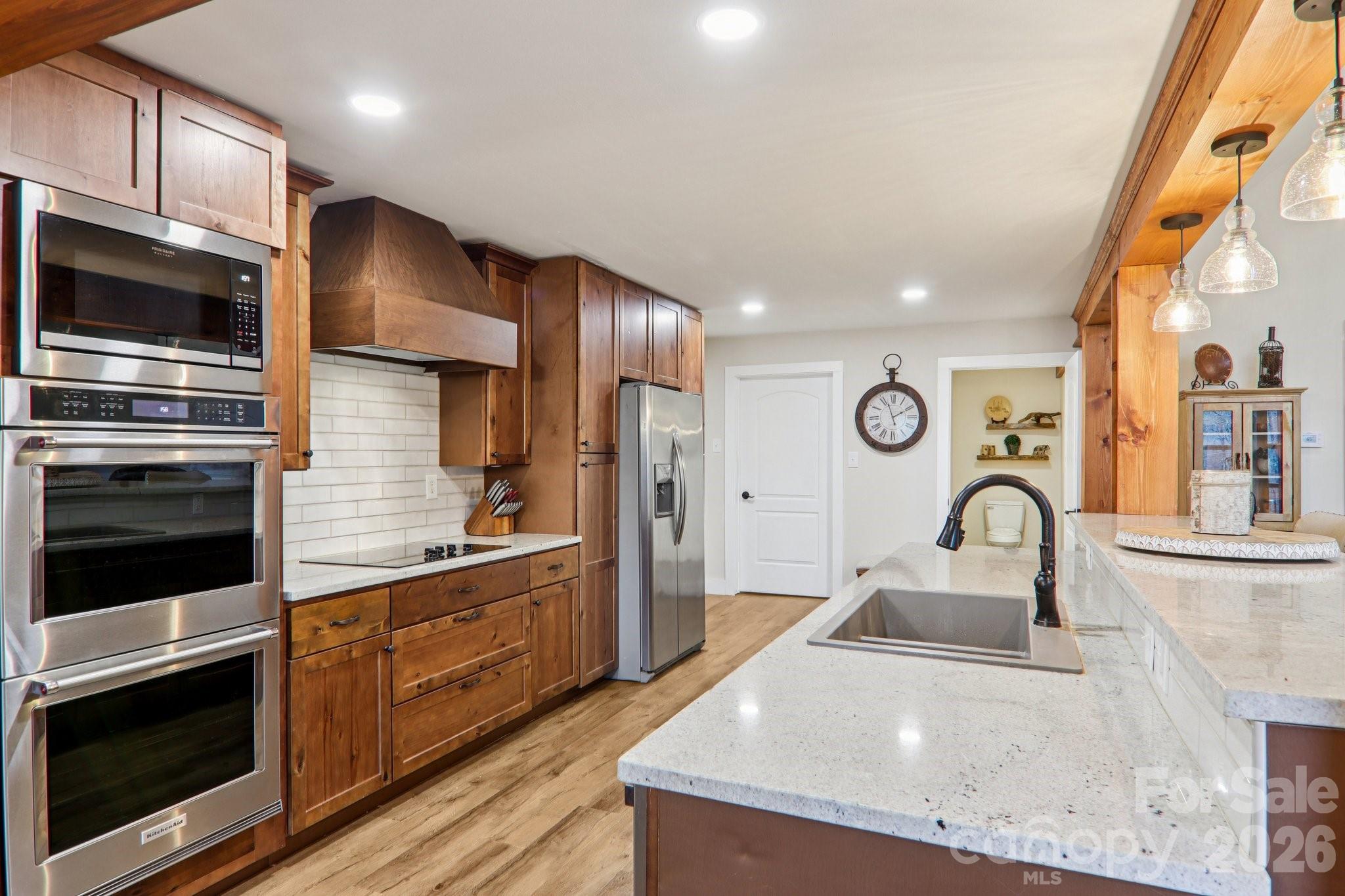 159 Broken Bow Run Pickens, SC 29671 - Photo 6 of 23 a kitchen with stainless steel appliances kitchen island granite countertop a stove a sink and a microwave