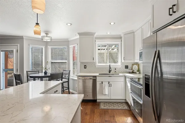 a kitchen with a sink stove and refrigerator