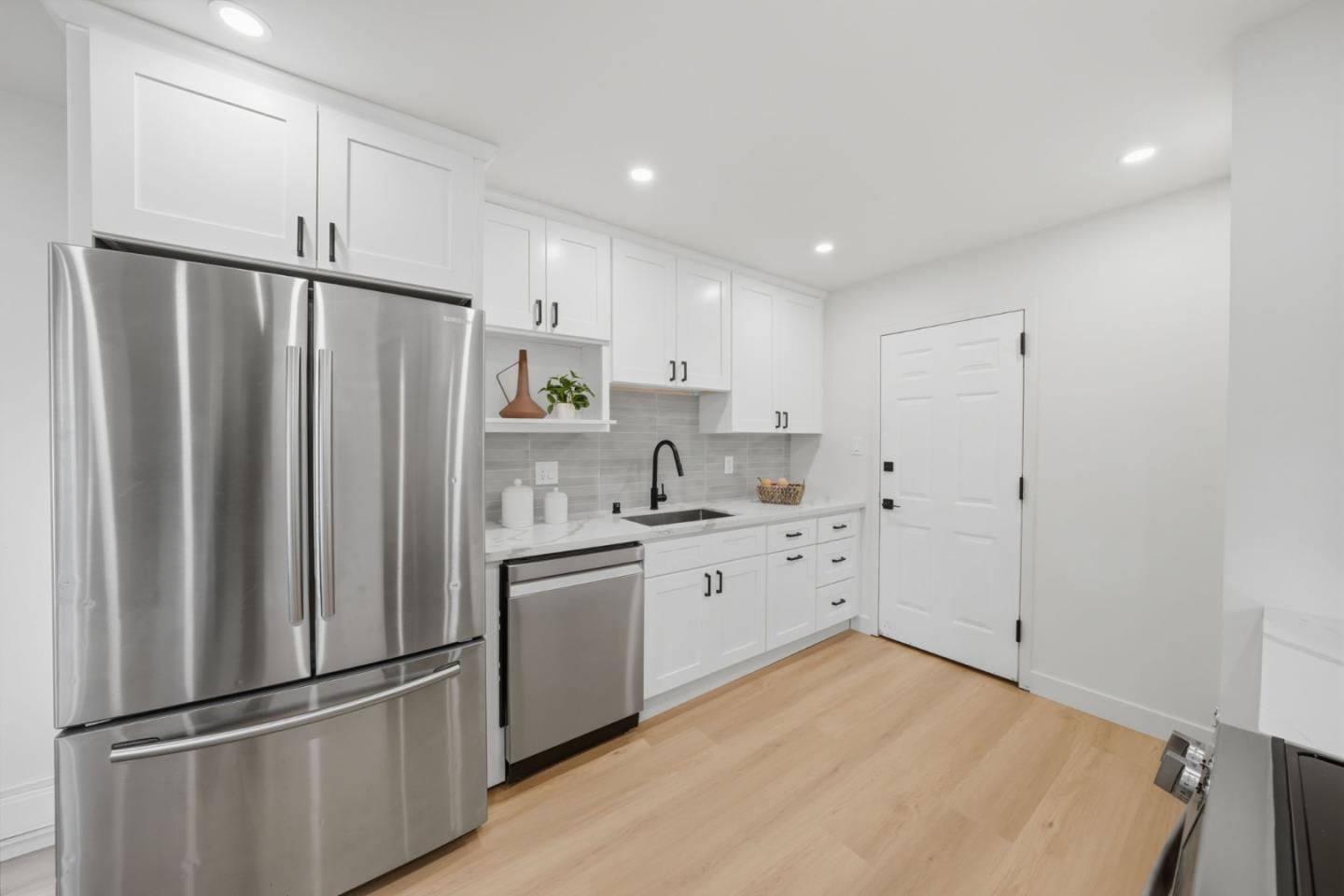 409 Puerto Place Hayward, CA 94541 - Photo 15 of 54 a kitchen with stainless steel appliances a refrigerator sink and cabinets