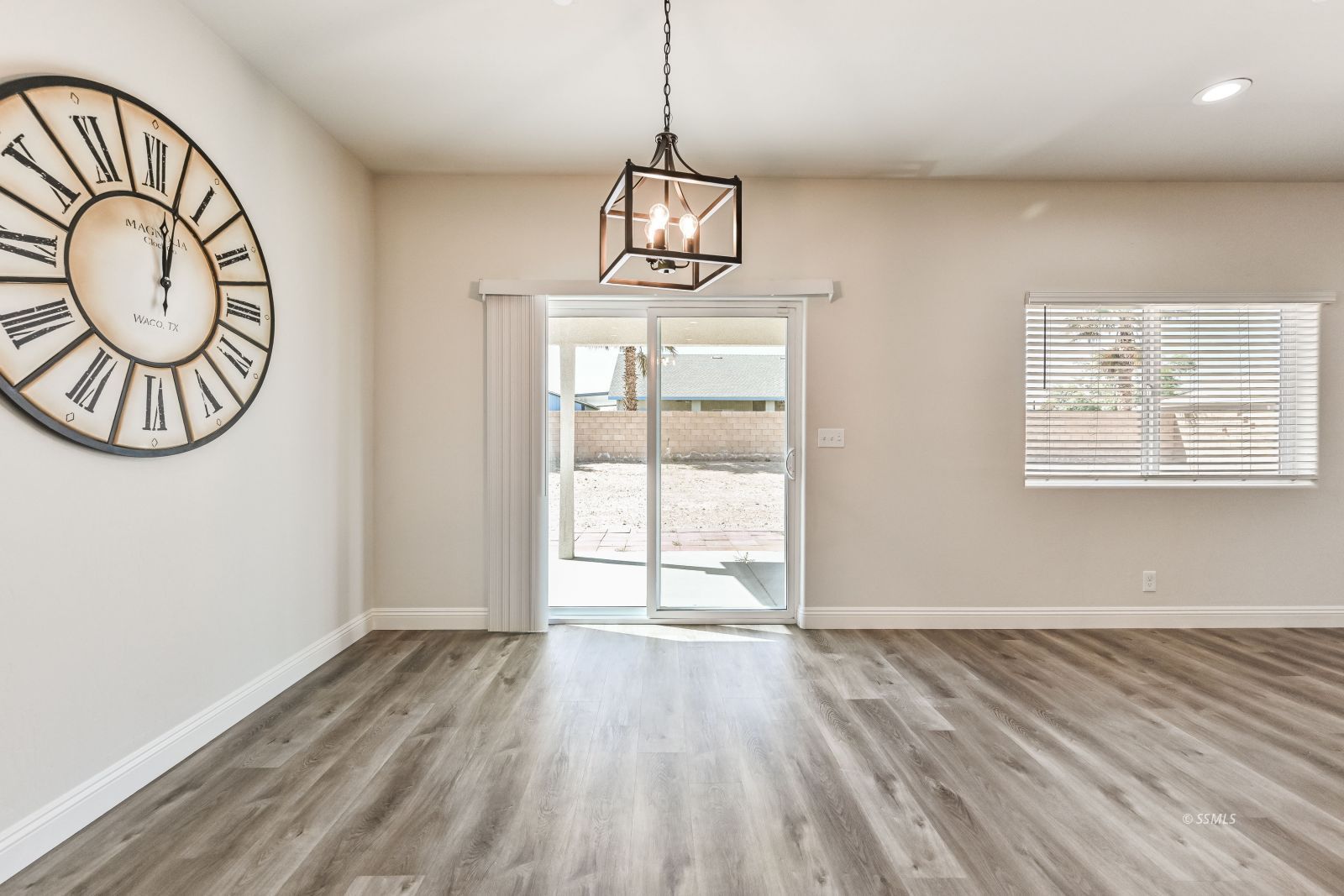 1031 West Church Avenue Ridgecrest, CA 93555 - Photo 17 of 49 a view of an empty room with window and wooden floor