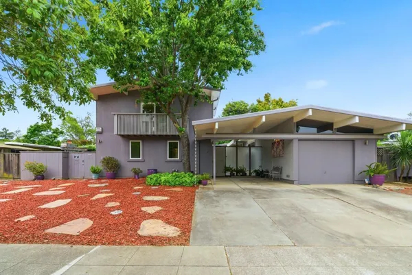 a front view of a house with a garden
