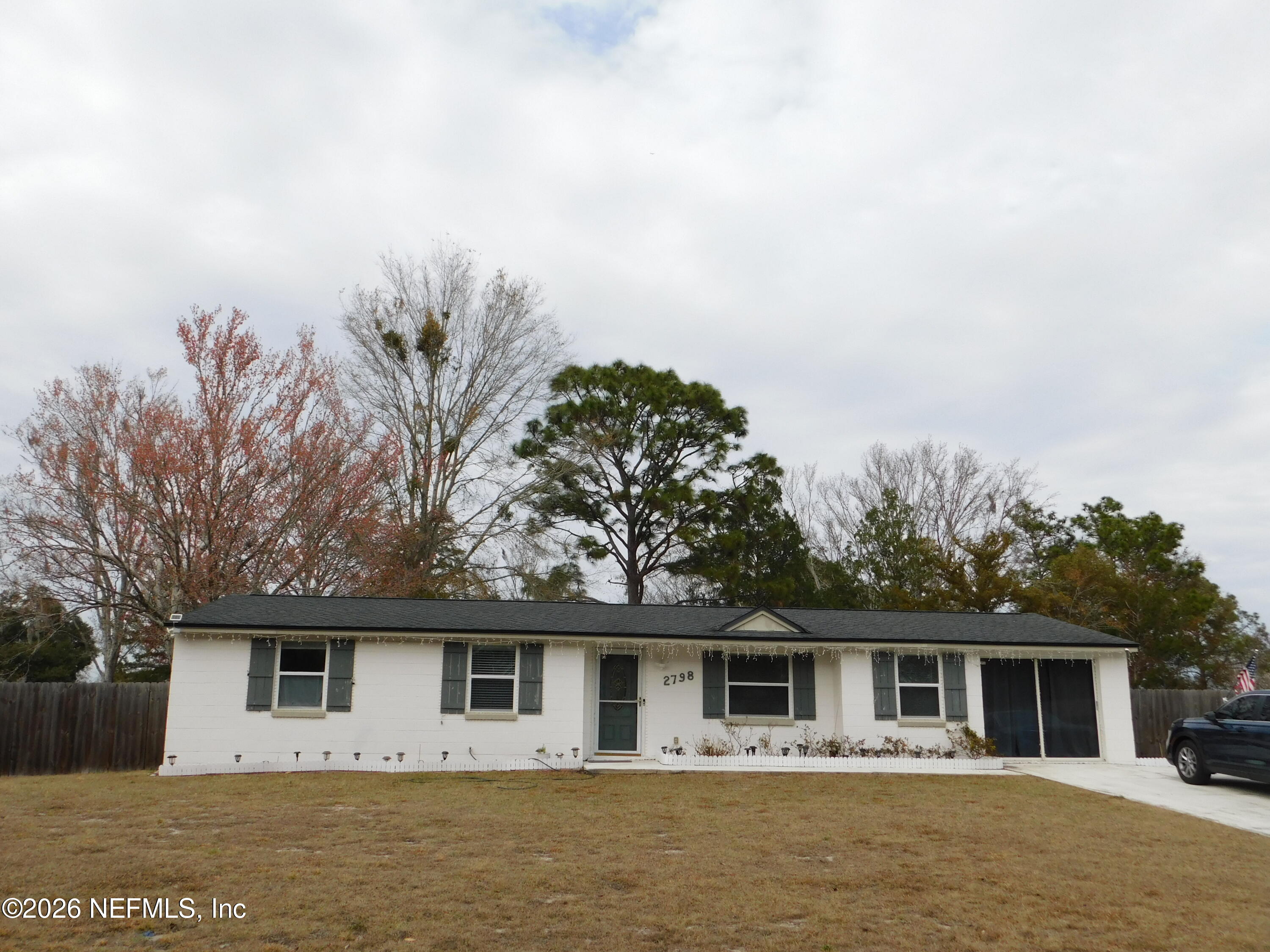2798 Commanche Avenue Orange Park, FL 32065 - Photo 1 of 42 a front view of house with yard and trees in the background