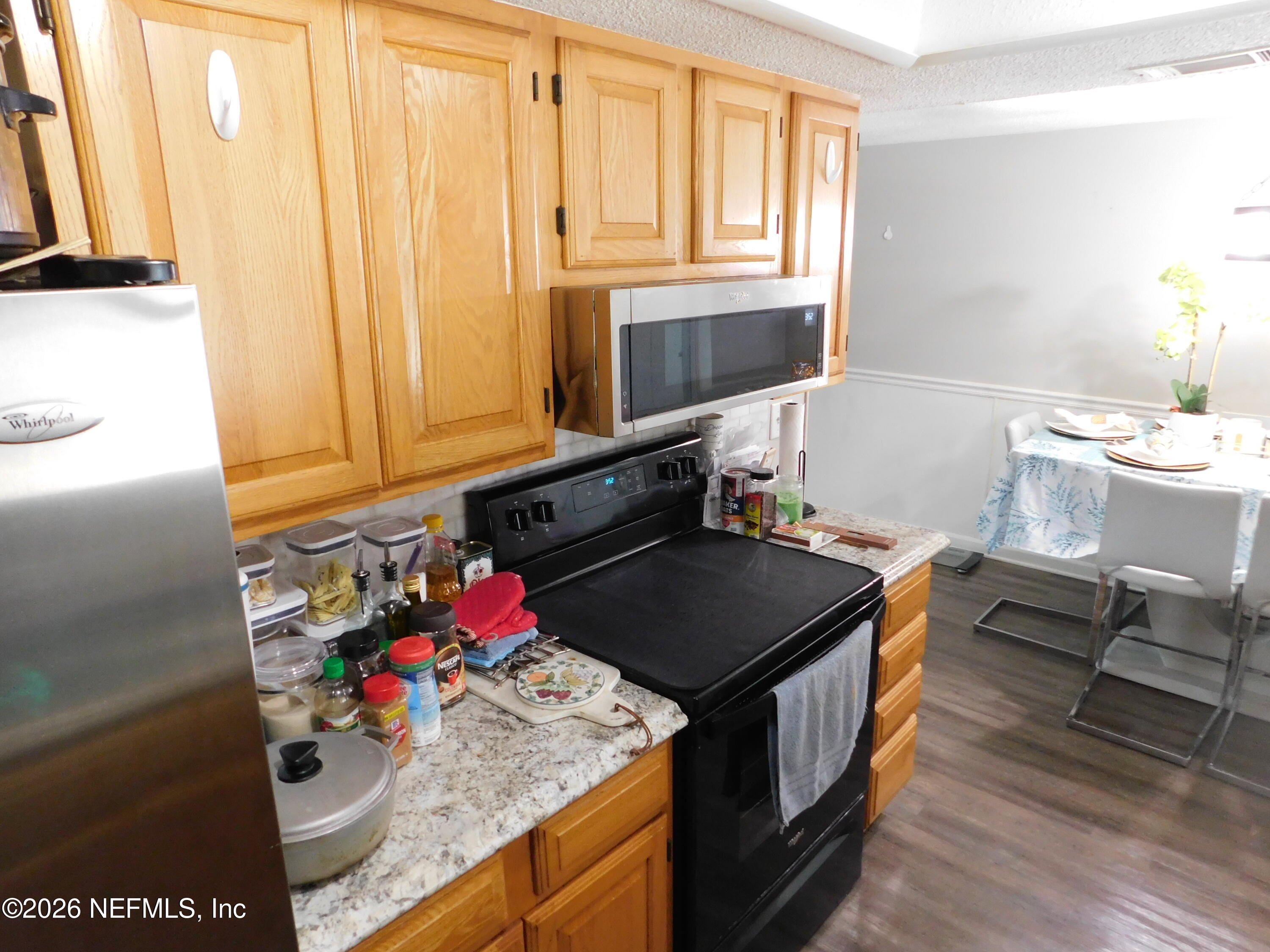 2798 Commanche Avenue Orange Park, FL 32065 - Photo 19 of 42 a kitchen with stainless steel appliances granite countertop a stove a sink and a refrigerator