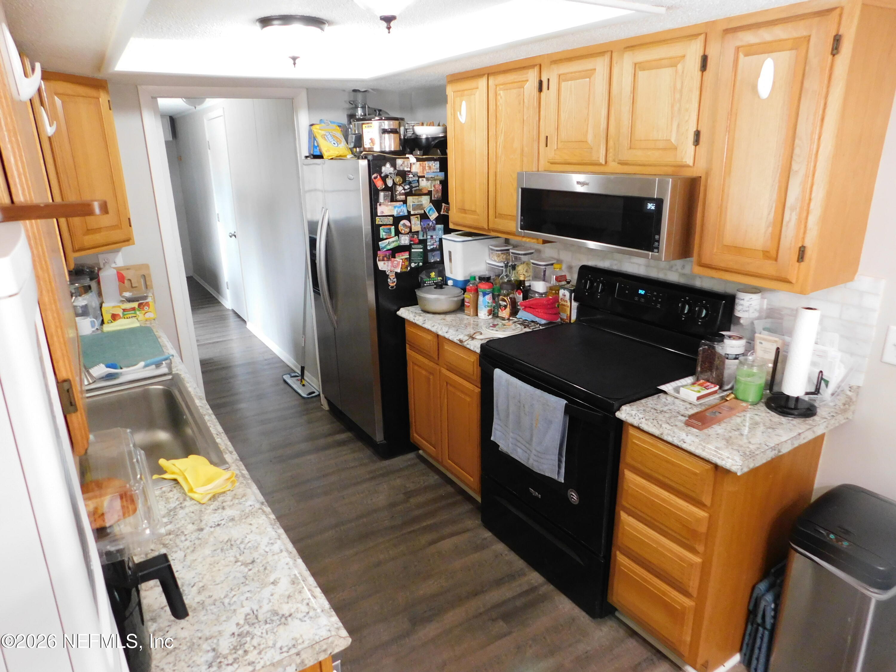 2798 Commanche Avenue Orange Park, FL 32065 - Photo 20 of 42 a kitchen with granite countertop a refrigerator stove and sink