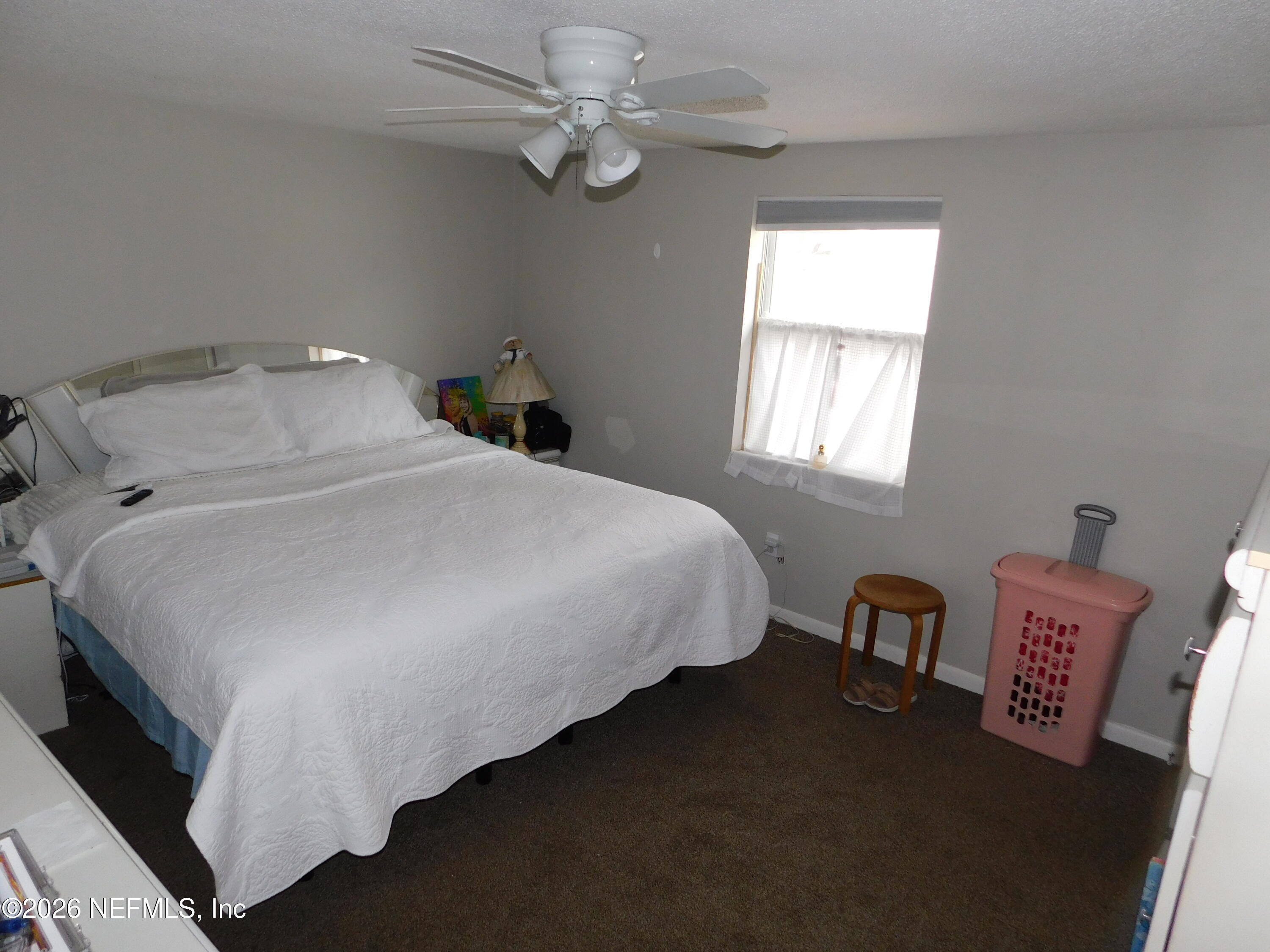 2798 Commanche Avenue Orange Park, FL 32065 - Photo 10 of 42 a bedroom with a bed and a chandelier