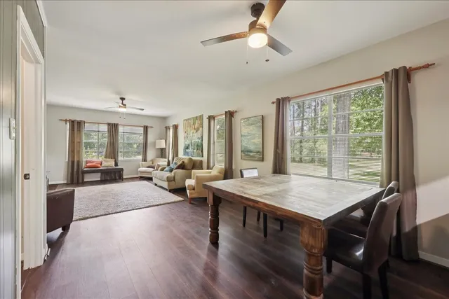 a view of a livingroom with furniture window and wooden floor