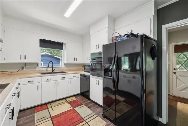a kitchen with a sink cabinets and refrigerator