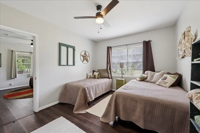 a bedroom with two beds and a window