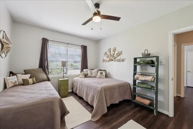 a bedroom with two beds and a window