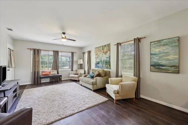 a living room with furniture and large windows