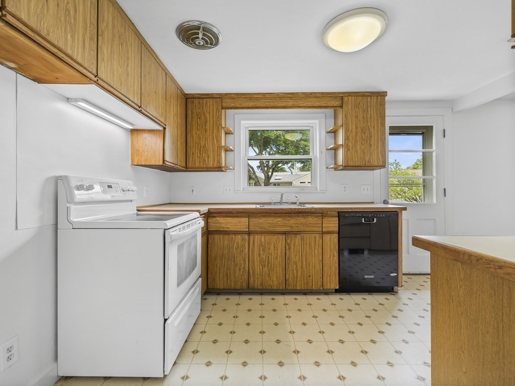 51 Albemarle Road Newton, MA 02460 - Photo 11 of 31 a kitchen with a stove a sink and a refrigerator