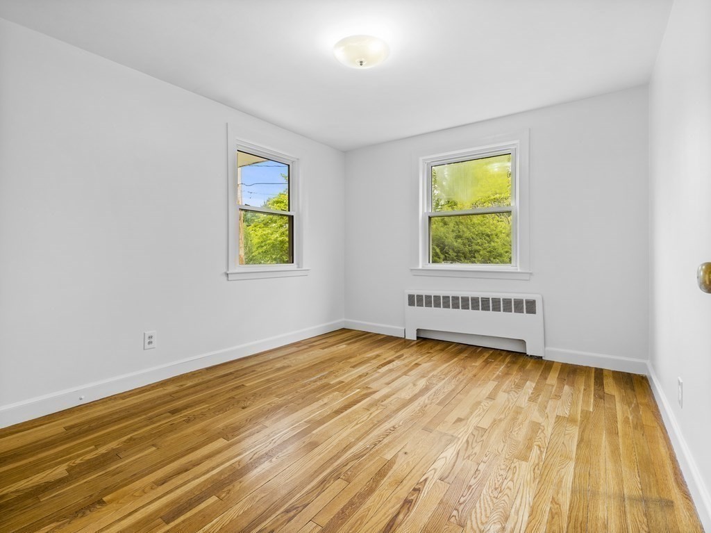 51 Albemarle Road Newton, MA 02460 - Photo 17 of 31 a view of an empty room with window and wooden floor