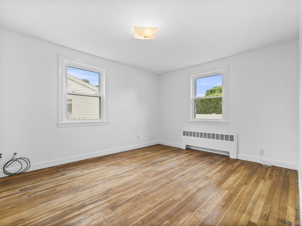 51 Albemarle Road Newton, MA 02460 - Photo 18 of 31 an empty room with wooden floor and windows