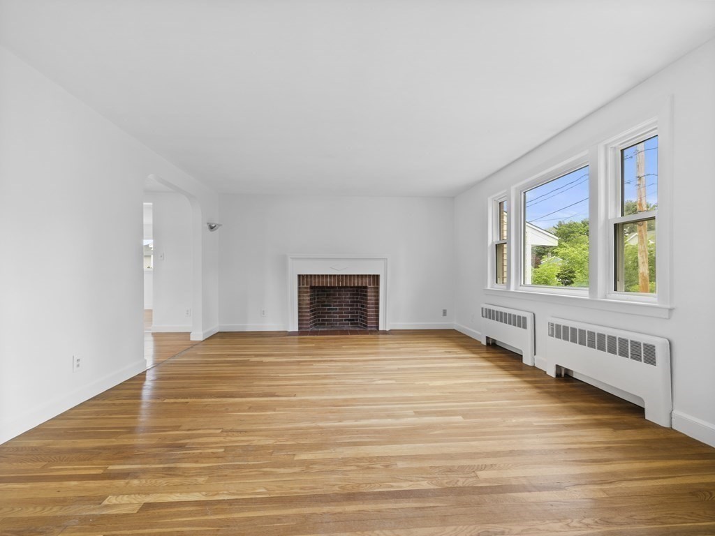 51 Albemarle Road Newton, MA 02460 - Photo 3 of 31 a view of an empty room with window and wooden floor