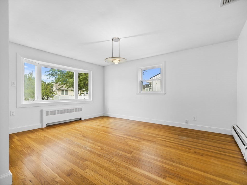 51 Albemarle Road Newton, MA 02460 - Photo 6 of 31 a view of an empty room with wooden floor and a window