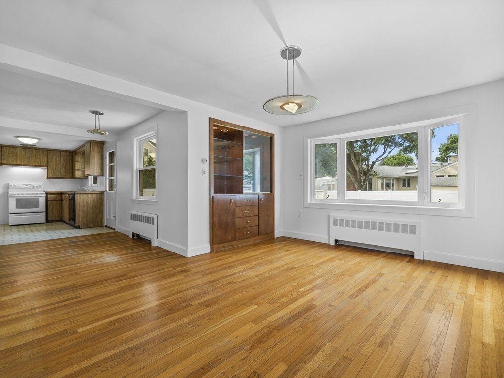 51 Albemarle Road Newton, MA 02460 - Photo 7 of 31 a view of an empty room with a window and wooden floor