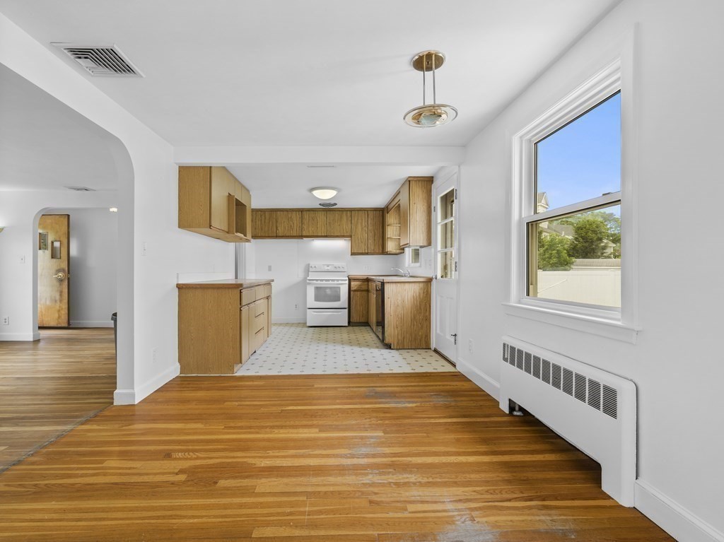 51 Albemarle Road Newton, MA 02460 - Photo 8 of 31 a spacious bedroom with a bed and a view of kitchen