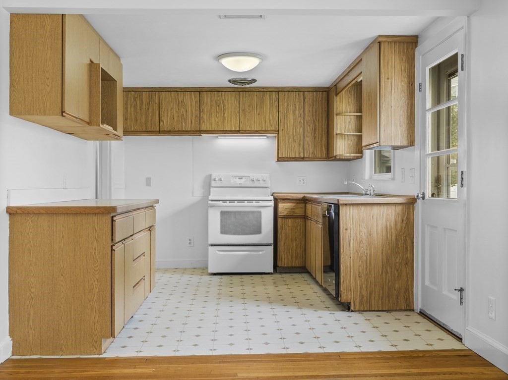 51 Albemarle Road Newton, MA 02460 - Photo 10 of 31 a kitchen with a stove a sink and a refrigerator